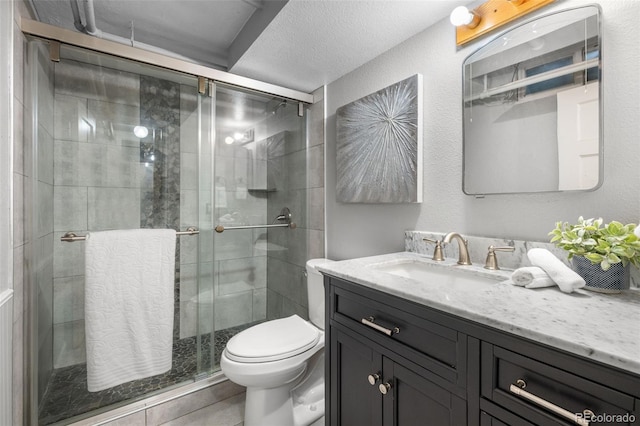 1033 Estes St, Lakewood, CO 80215 - bathroom featuring vanity, a stall shower, a textured ceiling, and tile patterned flooring