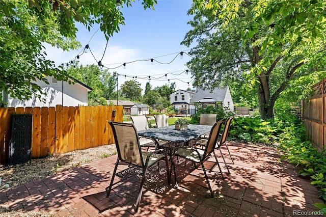 1033 Estes St, Lakewood, CO 80215 - fenced backyard with a patio area, outdoor dining area, and a shed