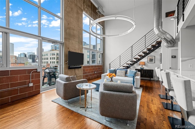 1050 Cherokee St Unit 403, Denver, CO 80204 - living area with a high ceiling, stairway, and wood finished floors