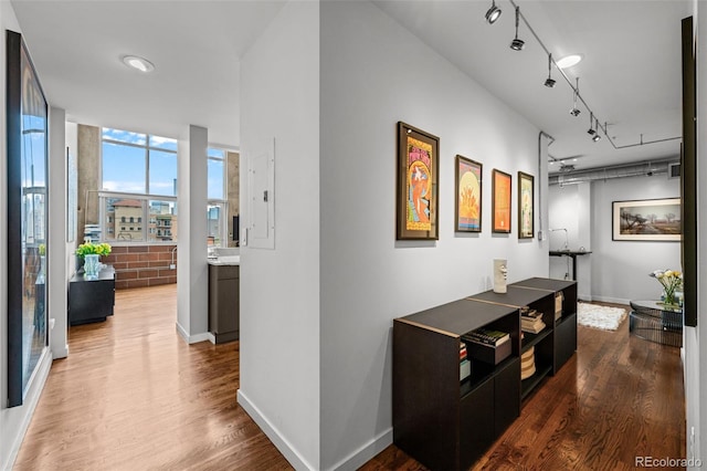1050 Cherokee St Unit 403, Denver, CO 80204 - hallway with rail lighting, dark wood finished floors, and baseboards