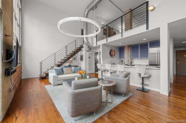 1050 Cherokee St Unit 403, Denver, CO 80204 - living area featuring stairway, wood finished floors, baseboards, and a high ceiling