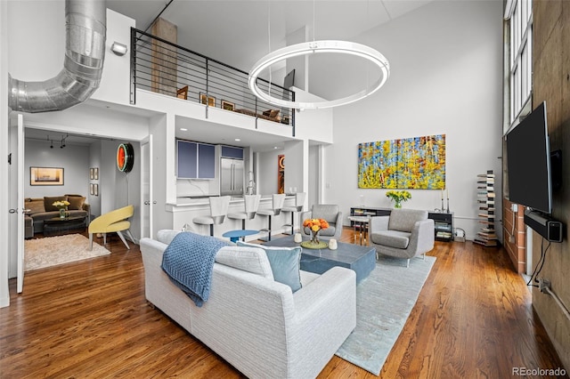 1050 Cherokee St Unit 403, Denver, CO 80204 - living area with a towering ceiling and wood finished floors