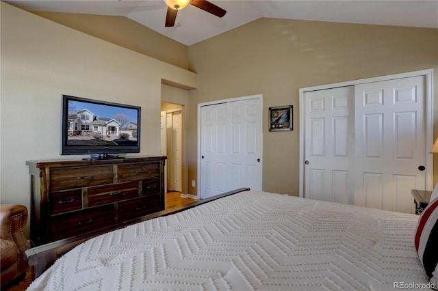 bedroom featuring two closets, ceiling fan, and vaulted ceiling