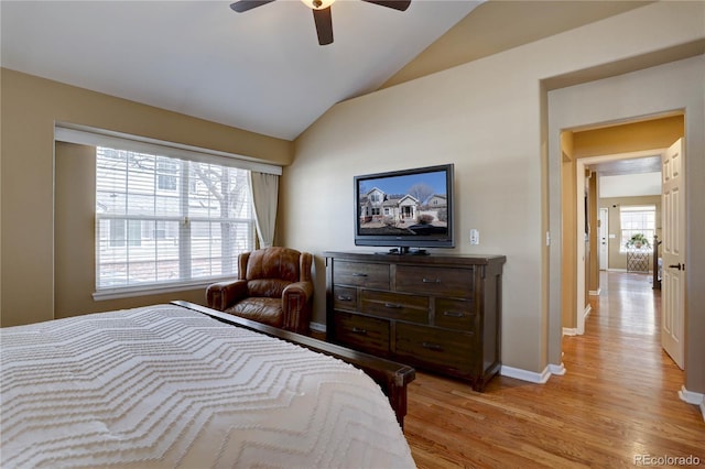 bedroom with lofted ceiling, light wood-style floors, baseboards, and ceiling fan