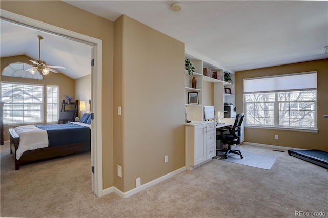 office with baseboards, light carpet, ceiling fan, and vaulted ceiling