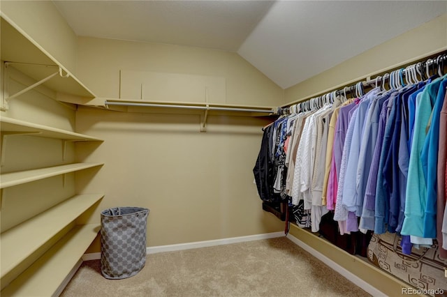 spacious closet with carpet and vaulted ceiling