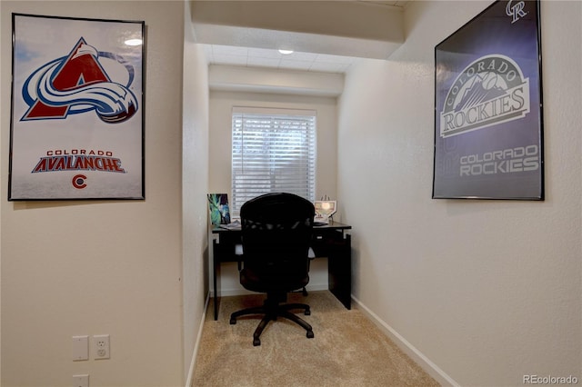 carpeted office space featuring baseboards