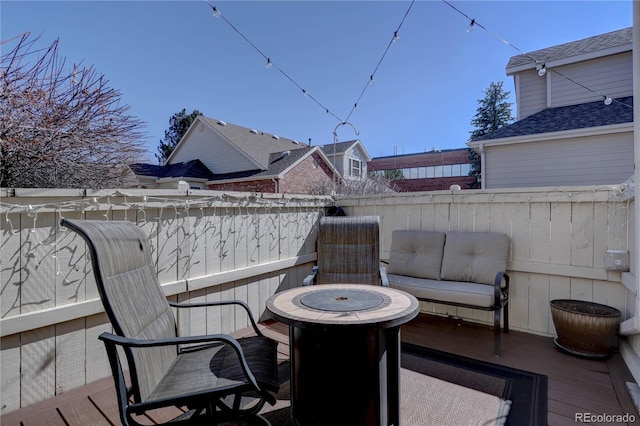 wooden terrace featuring a fire pit