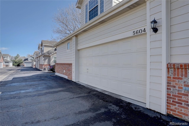 garage featuring a residential view and driveway