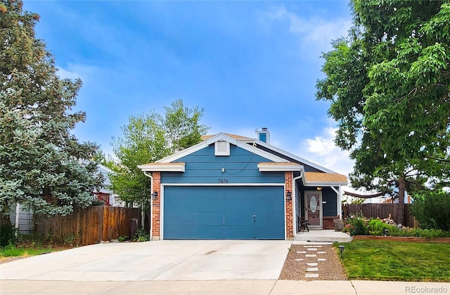 7978 S Johnson Ct, Littleton, CO 80128 - view of front of home featuring driveway, brick siding, and an attached garage