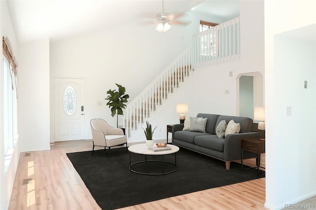 7978 S Johnson Ct, Littleton, CO 80128 - living area with a towering ceiling, wood finished floors, stairs, arched walkways, and ceiling fan