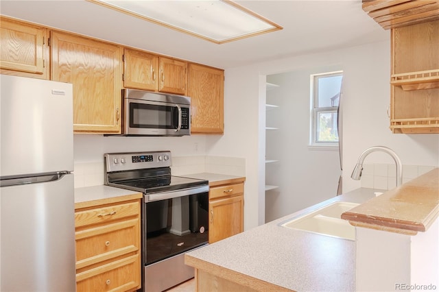 7978 S Johnson Ct, Littleton, CO 80128 - kitchen featuring stainless steel appliances, light countertops, open shelves, and light brown cabinetry