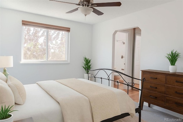 7978 S Johnson Ct, Littleton, CO 80128 - bedroom featuring arched walkways, light colored carpet, and ceiling fan