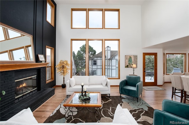 9983 Cottoncreek Dr, Highlands Ranch, CO 80130 - living area with a towering ceiling, wood finished floors, and a glass covered fireplace