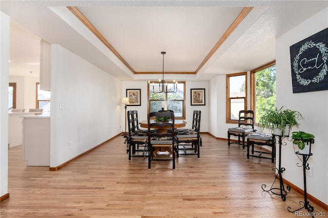 9983 Cottoncreek Dr, Highlands Ranch, CO 80130 - dining area with a tray ceiling, light wood finished floors, a chandelier, and crown molding