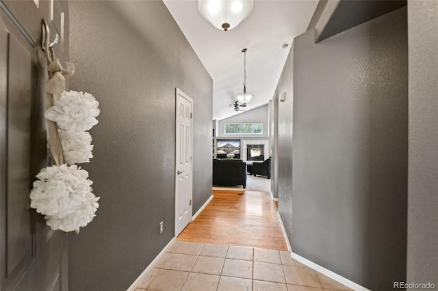 8829 S Dudley St, Littleton, CO 80128 - hallway with vaulted ceiling, light tile patterned floors, and a textured wall