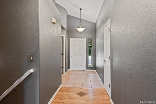 8829 S Dudley St, Littleton, CO 80128 - foyer featuring vaulted ceiling, light tile patterned flooring, and a textured wall