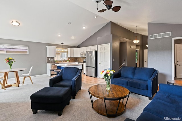 8829 S Dudley St, Littleton, CO 80128 - living area featuring ceiling fan, light carpet, recessed lighting, and high vaulted ceiling