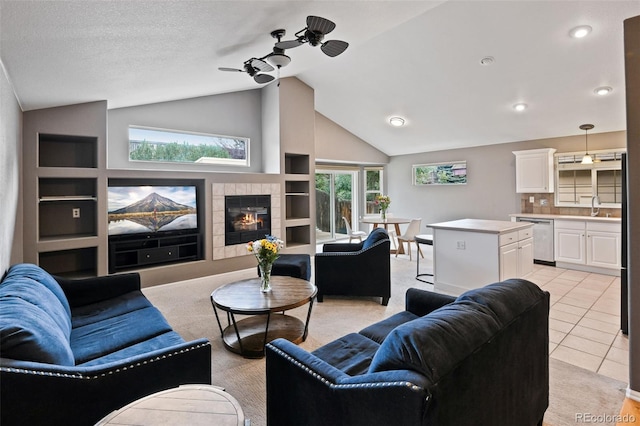 8829 S Dudley St, Littleton, CO 80128 - living area with lofted ceiling, a ceiling fan, and a tile fireplace