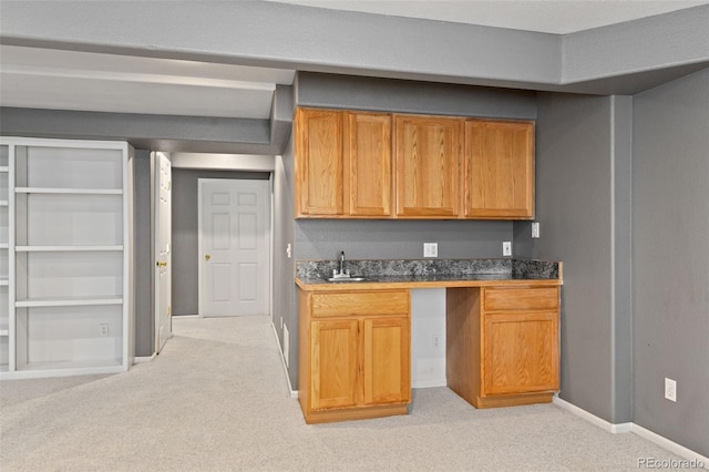 8829 S Dudley St, Littleton, CO 80128 - kitchen featuring light colored carpet and brown cabinets