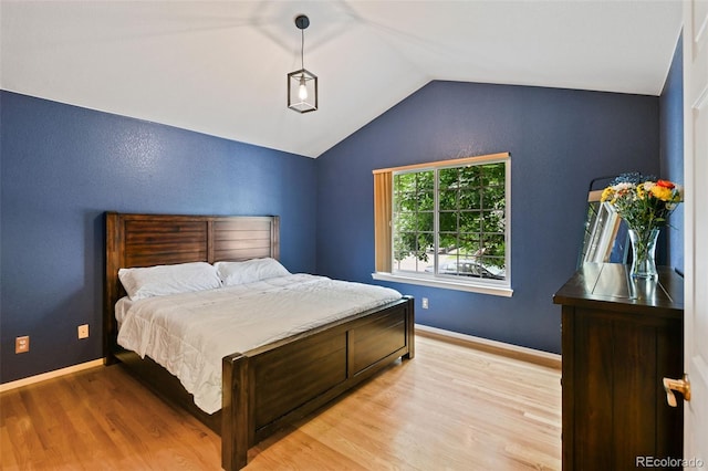 8829 S Dudley St, Littleton, CO 80128 - bedroom with vaulted ceiling and light wood-style flooring