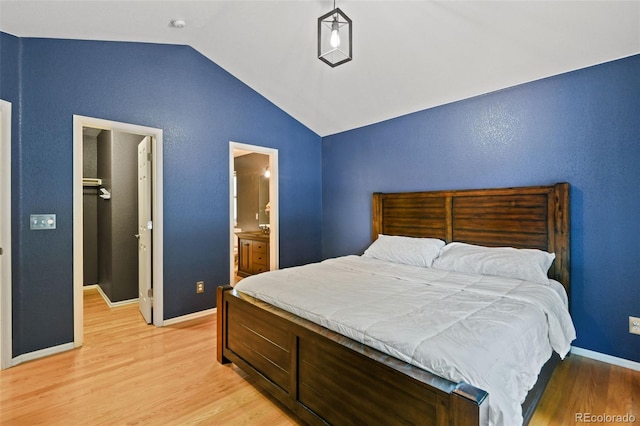 8829 S Dudley St, Littleton, CO 80128 - bedroom with lofted ceiling, light wood-style flooring, and ensuite bath