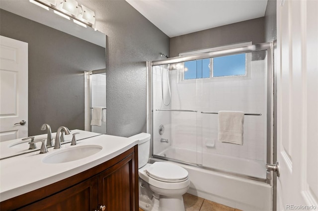 8829 S Dudley St, Littleton, CO 80128 - full bathroom with vanity, shower / bath combination with glass door, a textured wall, and tile patterned flooring