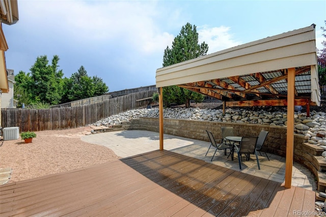 8829 S Dudley St, Littleton, CO 80128 - wooden terrace featuring a fenced backyard, outdoor dining space, and a patio