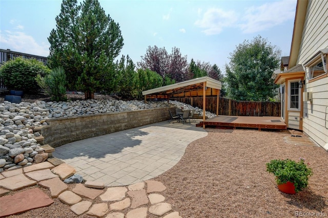 8829 S Dudley St, Littleton, CO 80128 - fenced backyard featuring a patio area and a wooden deck