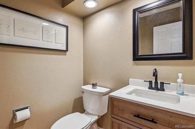 6062 S Emporia Cir, Englewood, CO 80111 - bathroom featuring vanity, a textured wall, and toilet