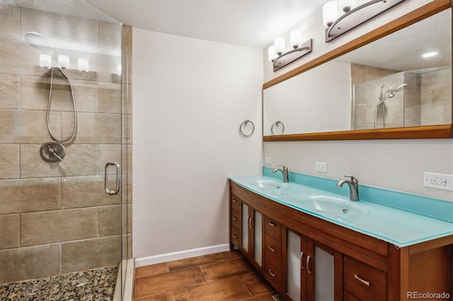 6062 S Emporia Cir, Englewood, CO 80111 - bathroom with double vanity, baseboards, a shower stall, and a sink