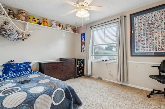 6062 S Emporia Cir, Englewood, CO 80111 - carpeted bedroom with a textured ceiling, baseboards, visible vents, and ceiling fan