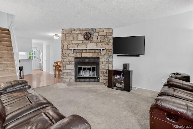 8108 S Fillmore Cir, Centennial, CO 80122 - carpeted living room with stairway, a textured ceiling, and a fireplace