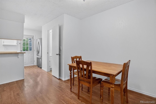 8108 S Fillmore Cir, Centennial, CO 80122 - dining space featuring light wood-type flooring and a textured ceiling