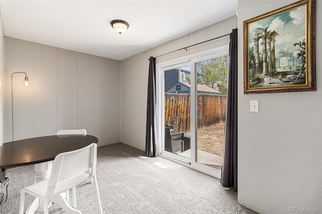 office space featuring light carpet and a textured ceiling
