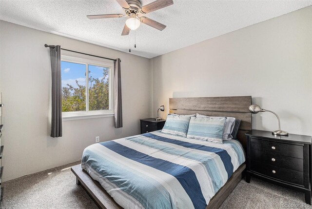 carpeted bedroom featuring a textured ceiling and a ceiling fan