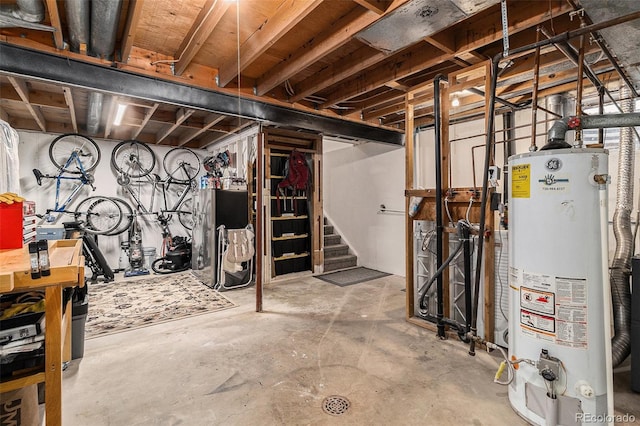 unfinished below grade area featuring gas water heater and stairs