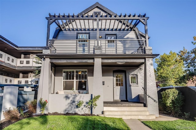 view of front of home with a balcony and a pergola