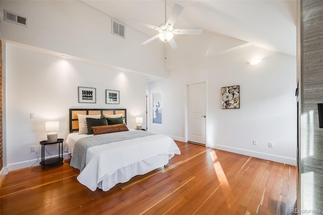 bedroom with ceiling fan, wood-type flooring, and high vaulted ceiling