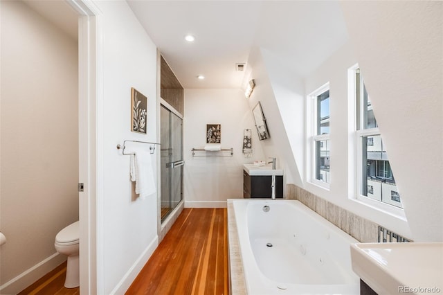 full bathroom featuring hardwood / wood-style flooring, vanity, toilet, and independent shower and bath