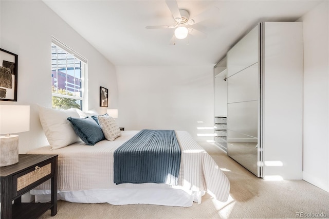 bedroom with light colored carpet and ceiling fan