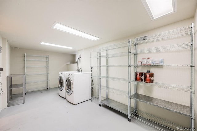 clothes washing area with washer and clothes dryer