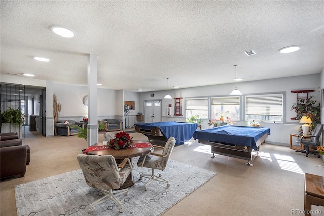 game room with a textured ceiling, light carpet, and billiards