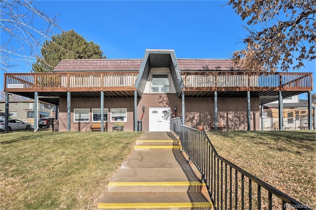 rear view of property with a yard and a wooden deck