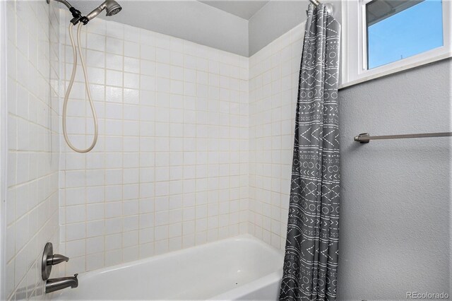 bathroom featuring shower / bathtub combination with curtain