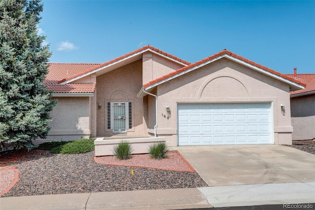 160 Las Lunas St, Castle Rock, CO 80104 - mediterranean / spanish house featuring a garage, stucco siding, and a tile roof