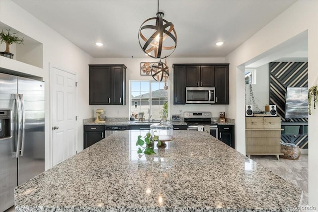 239 S Old Hammer St, Aurora, CO 80018 - kitchen featuring stainless steel appliances, a center island, light stone counters, pendant lighting, and recessed lighting