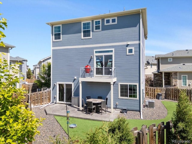 239 S Old Hammer St, Aurora, CO 80018 - rear view of house with a patio area, a fenced backyard, and a balcony