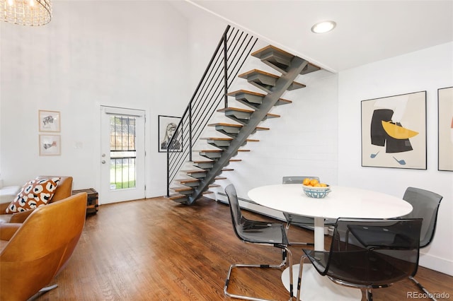 505 Detroit St, Denver, CO 80206 - dining area with stairway, wood finished floors, recessed lighting, a high ceiling, and a chandelier