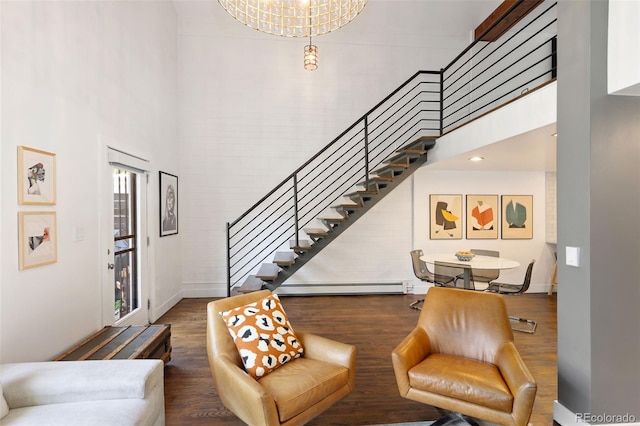 505 Detroit St, Denver, CO 80206 - living area with a high ceiling, stairway, a baseboard heating unit, and wood finished floors